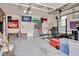 Spacious garage with a variety of unique flags hanging above the doors and a weight-lifting station off to the side at 810 Warwick Ct, Burlington, NC 27215