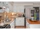Well-lit kitchen with white cabinets, granite counters, stainless steel appliances, and decorative hardware at 810 Warwick Ct, Burlington, NC 27215