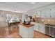 Sunlit kitchen and breakfast nook features white cabinets, granite countertops, and stainless appliances at 810 Warwick Ct, Burlington, NC 27215
