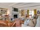 Cozy living room featuring a brick fireplace, neutral sofa, and abundant natural light at 810 Warwick Ct, Burlington, NC 27215