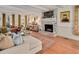 Bright living room with fireplace, neutral couch, and hardwood flooring at 810 Warwick Ct, Burlington, NC 27215