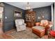 Cozy living room with dark walls, wood trim, a chandelier, and unique decor elements at 810 Warwick Ct, Burlington, NC 27215