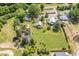 Expansive aerial view showcasing a farm-style home, silo, green lawn, and multiple outbuildings on a large lot at 8324 Humie Olive Rd, Apex, NC 27502