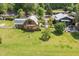 Aerial view of the estate featuring manicured lawns, multiple buildings, and gardens at 8324 Humie Olive Rd, Apex, NC 27502
