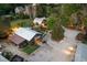 A bird's eye view of the expansive property including several structures, silo, lush greenery, and ample parking at 8324 Humie Olive Rd, Apex, NC 27502
