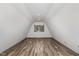 The attic space features wood laminate flooring, a dormer, and recessed lighting at 8324 Humie Olive Rd, Apex, NC 27502