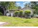 Backyard view features a well-maintained lawn, trees, and a charming house exterior at 8324 Humie Olive Rd, Apex, NC 27502