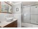 Bathroom showcasing a stylish vessel sink, a gold-framed mirror, subway tile, and a glass-enclosed shower at 8324 Humie Olive Rd, Apex, NC 27502