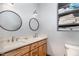 Bright bathroom with a double vanity, modern fixtures, and a built-in storage cabinet at 8324 Humie Olive Rd, Apex, NC 27502