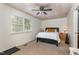 Bedroom showcasing a black bed with white comforter, side tables with lamps, and a ceiling with wooden planks at 8324 Humie Olive Rd, Apex, NC 27502