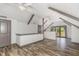 This bonus room has wood plank flooring, neutral walls, wood beams, and a sliding glass door for deck access at 8324 Humie Olive Rd, Apex, NC 27502