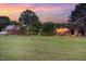 This stunning property showcases multiple buildings surrounded by lush green grass, with mature trees providing privacy at 8324 Humie Olive Rd, Apex, NC 27502