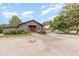 Charming home featuring gravel driveway, red door, well maintained landscaping, and a detached barn at 8324 Humie Olive Rd, Apex, NC 27502