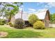 Exterior view of a rustic barn-style house with a metal roof and a well-manicured lawn and landscaping at 8324 Humie Olive Rd, Apex, NC 27502