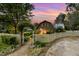 Stone path and white picket fence lead to the charming barn featuring a stone facade and well-lit entry at 8324 Humie Olive Rd, Apex, NC 27502