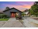 Modern farmhouse with a striking red double-door entrance, stone pathway, and professionally landscaped yard at 8324 Humie Olive Rd, Apex, NC 27502