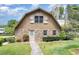 Charming barn-style home with stone accents, a well-maintained lawn, and mature landscaping at 8324 Humie Olive Rd, Apex, NC 27502