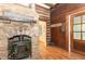 Cozy fireplace with stone surround and rustic log cabin accents, perfect for relaxing evenings at 8324 Humie Olive Rd, Apex, NC 27502