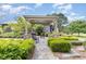 Landscaped garden path with pergola and rocking chairs for tranquil outdoor living at 8324 Humie Olive Rd, Apex, NC 27502