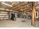 Spacious interior view of the storage building with exposed beams and organized storage at 8324 Humie Olive Rd, Apex, NC 27502