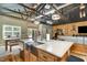 Bright kitchen with stainless steel sink, custom wood cabinets, and breakfast bar seating at 8324 Humie Olive Rd, Apex, NC 27502