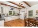 Well-lit kitchen featuring white cabinets, farmhouse sink, and stainless steel appliances at 8324 Humie Olive Rd, Apex, NC 27502
