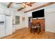Open kitchen with white cabinets, a dining table, and a view of the fireplace at 8324 Humie Olive Rd, Apex, NC 27502