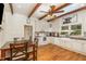 Bright kitchen with white cabinetry, modern appliances, and a cozy dining area with stylish lighting at 8324 Humie Olive Rd, Apex, NC 27502