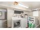 Bright laundry room equipped with modern washer and dryer units at 8324 Humie Olive Rd, Apex, NC 27502