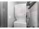 Efficient laundry room with a stacked washer and dryer set and convenient storage space at 8324 Humie Olive Rd, Apex, NC 27502