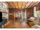 Rustic living room boasts exposed wood beams, wood burning fireplace and natural light at 8324 Humie Olive Rd, Apex, NC 27502