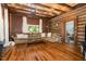 Inviting living room featuring wood paneled walls, hardwood floors, and comfortable seating at 8324 Humie Olive Rd, Apex, NC 27502
