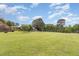 Expansive green lawn with multiple buildings, gardens, and trees for a serene setting at 8324 Humie Olive Rd, Apex, NC 27502