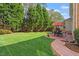 Spacious backyard with lush green lawn, mature trees, and an outdoor dining area at 8912 Riverview Park Dr, Raleigh, NC 27613