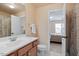 Bright bathroom features a single vanity, neutral walls, and a view to the bedroom at 8912 Riverview Park Dr, Raleigh, NC 27613