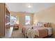 Well-lit bedroom with a queen-size bed, desk, and built-in shelves at 8912 Riverview Park Dr, Raleigh, NC 27613
