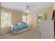 Bright bedroom with a ceiling fan, two windows, and a white bookcase at 8912 Riverview Park Dr, Raleigh, NC 27613