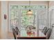 A sunlit dining room featuring an oversized window that looks out to a lush wooded view at 8912 Riverview Park Dr, Raleigh, NC 27613