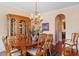 Formal dining room showcasing hardwood floors, crown molding, and a large china cabinet at 8912 Riverview Park Dr, Raleigh, NC 27613