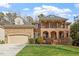 Charming two-story brick home featuring a manicured lawn and a welcoming front porch at 8912 Riverview Park Dr, Raleigh, NC 27613