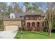 Traditional brick home boasts manicured lawn and attached garage at 8912 Riverview Park Dr, Raleigh, NC 27613