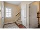 Inviting foyer with hardwood floors, staircase, and a window letting in natural light at 8912 Riverview Park Dr, Raleigh, NC 27613