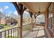 Charming front porch with decorative pillars and iron railings, perfect for enjoying the neighborhood views at 8912 Riverview Park Dr, Raleigh, NC 27613