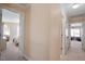 Hallway featuring multiple doorways leading to different rooms with carpeted floors at 8912 Riverview Park Dr, Raleigh, NC 27613