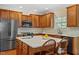 The open kitchen offers an island with seating, stainless appliances, and a large window at 8912 Riverview Park Dr, Raleigh, NC 27613