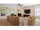 Enjoy the fireplace in this living room with a large sofa and oversized window at 8912 Riverview Park Dr, Raleigh, NC 27613