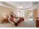 Tranquil main bedroom with tray ceiling, windows, and balcony access, with a queen size bed at 8912 Riverview Park Dr, Raleigh, NC 27613