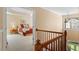 Comfortable main bedroom with tray ceiling, large windows, and a view from the second floor at 8912 Riverview Park Dr, Raleigh, NC 27613