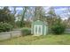 Charming green and white storage shed in a well-maintained backyard at 100 E Delafield Ave, Durham, NC 27704