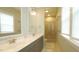 This bathroom has a double sink and a glass shower at 100 E Delafield Ave, Durham, NC 27704